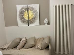 a living room with a couch and a radiator at URBAN SUITE in Bari