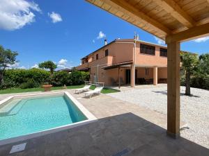 une vue extérieure d'une maison avec piscine dans l'établissement Holiday Home Tuscania by Interhome, à Bibbona