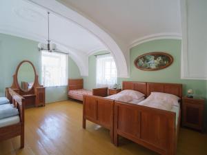 a large bedroom with two beds and a mirror at Holiday Home Kojetice na Moravě by Interhome in Kojetice