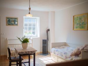 a bedroom with a bed and a table and a window at Holiday Home Kojetice na Moravě by Interhome in Kojetice