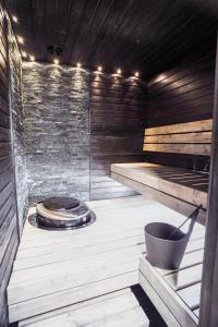 a sauna with a stove in the middle of a room at Ruka Twin 3 bedroom Villa with Jacuzzi by Rukalodges in Ruka