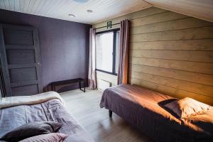 una camera da letto con due letti e una finestra di Ruka Twin 3 bedroom Villa with Jacuzzi by Rukalodges a Ruka