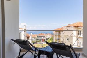 two chairs on a balcony with a view of the ocean at The Olympus Estate in Litochoro