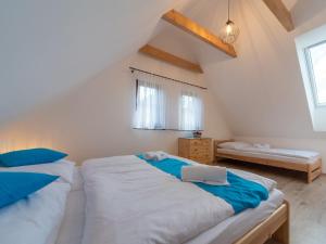 a bedroom with two beds in a attic at Holiday Home Cilka 1 by Interhome in Stráž nad Nežárkou