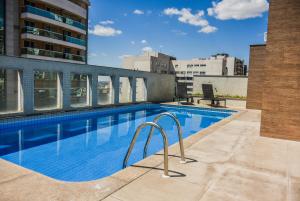 a swimming pool on the roof of a building at Mont Blanc Apart Hotel Nova Iguaçu in Nova Iguaçu