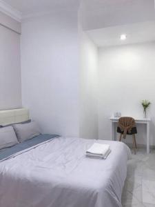 a white bedroom with a bed and a desk at Family 4BR Landed House @ SPICE ARENA in Bayan Lepas