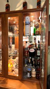 a cabinet filled with lots of bottles of alcohol at Elias Basilica Rooftop Penthouse in Nazareth