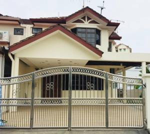 a large house with a gate in front of it at Family 4BR Landed House @ SPICE ARENA in Bayan Lepas