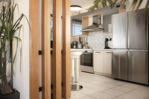 a kitchen with a stainless steel refrigerator and white cabinets at Exotic Master-House in a Unique Location! in Lithakia