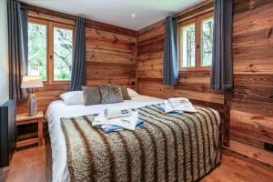 a bedroom with a bed in a room with wooden walls at Chalet du Dard - Chamonix All Year in Chamonix-Mont-Blanc