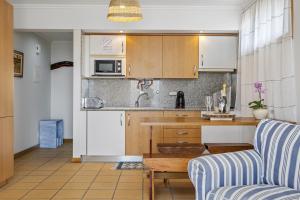 a kitchen with a couch and a table in a room at Casa Anaim by Homie in Lapeiras