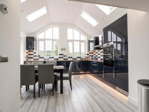 a dining room with a table and chairs at Braeface Cottage in Bonnybridge