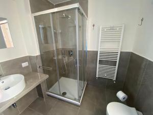 a bathroom with a shower and a toilet and a sink at AmMARE in Crotone