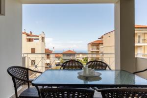 a table and chairs on a balcony with a view at The Olympus Estate in Litochoro