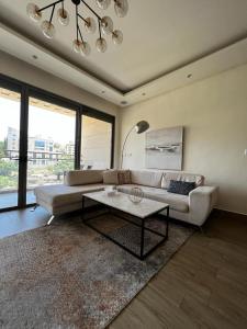 a living room with a couch and a coffee table at The bridge Residence in Amman