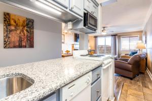 a kitchen with a sink and a counter top at SKY HIGH VIEWS!!-Peak Mountaintop-Outdoor Pool-Close to Downtown-Private Balcony-WiFi-Cable in Gatlinburg +62 photos