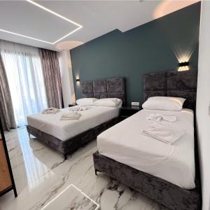 Postel nebo postele na pokoji v ubytování Poseidon Hotel 2 Ksamil