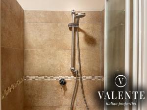 a shower in a bathroom with a glass door at Via Ruga degli Orlandi - Valente Italian Properties in Pescia