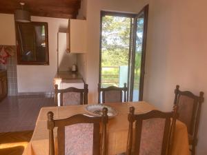 a table and chairs in a kitchen with a window at Kuca Dacica in Žabljak
