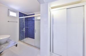 a bathroom with a glass shower and a sink at Elit Hotel Kas in Kaş