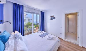 a bedroom with a bed and a large window at Elit Hotel Kas in Kaş