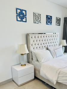 a bedroom with two beds and a lamp on a night stand at The Signature Apartments, Accra Ghana in Accra