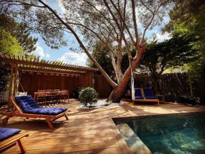 a patio with two chairs and a swimming pool at La Villa Familiale La Palmyre in Les Mathes