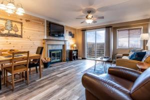 a living room with a couch and a table at SKY HIGH VIEWS!!-Peak Mountaintop-Outdoor Pool-Close to Downtown-Private Balcony-WiFi-Cable in Gatlinburg