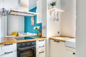 a kitchen with a sink and a stove at ALTIDO Delightful flat with terrace in Milan