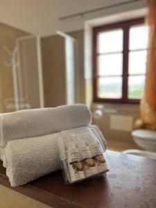a package of bottles of soap sitting next to a towel at Locanda Su mere b&d in Cheremule