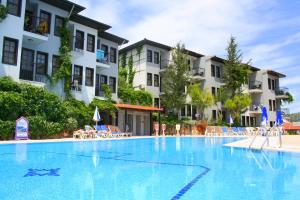 a large swimming pool in front of some buildings at Hisar Holiday Club in Oludeniz