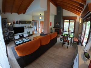 an open living room with a couch and chairs at Casa roja in Marrón
