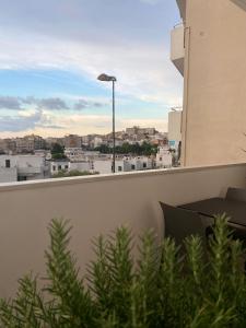 a balcony with a view of a city at ViesteRooms in Vieste