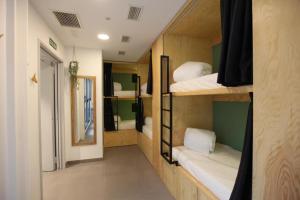 a room with four bunk beds and a hallway at AZ The Botanic Hostel in Zaragoza