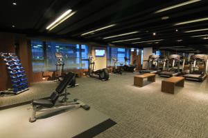 a gym with several treadmills and exercise machines at Silks Place Tainan in Tainan