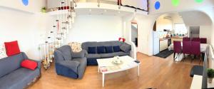 a living room with a couch and a table at Penthouse Familly Orešković in Zagreb