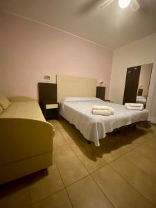 a bedroom with a large bed and a couch at HOTEL DA MIMMO in Bellaria-Igea Marina