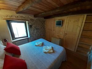 a bedroom with a bed with two boxes on it at La Casa Torre in Pignone