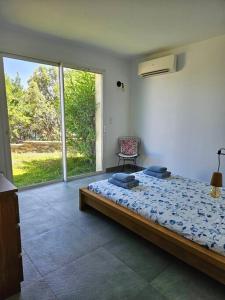 1 dormitorio con cama y ventana grande en Belle villa avec vue sur mer d'exception- Meria, en Meria