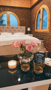a bedroom with a bed and a table with flowers and a candle at Apartman17 in Belgrade