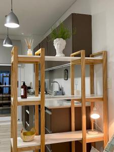a kitchen with a wooden shelving unit at MAO Buenos Aires - Apt. en Recoleta in Buenos Aires
