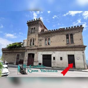 an old building with a red arrow in front of it at Il Castello casa vacanza in Salerno