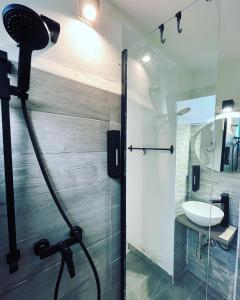 a bathroom with a shower and a sink at HomeSuite22 in Diamante