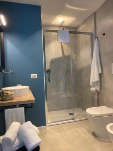 a bathroom with a shower and a toilet and a sink at ViesteRooms in Vieste