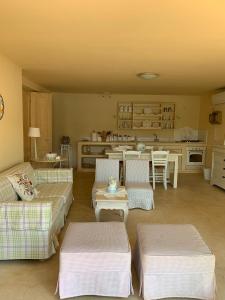 a living room with two couches and a kitchen at Endless Seaview in Porto Rafti