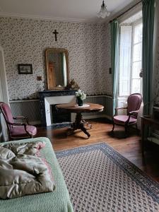 a bedroom with a bed and a table and a mirror at Manoir près de La Baule in Saint-Lyphard