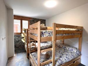 a bedroom with four bunk beds in a room at Casa L'Isard - Anàs 