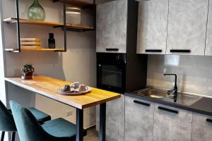a kitchen with a table and chairs and a sink at 24 Maggio Apartment in Galatina +8 photos