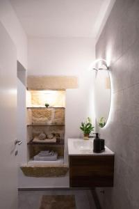a bathroom with a sink and a mirror at 24 Maggio Apartment in Galatina