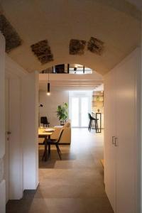a living room with a table and a dining room at 24 Maggio Apartment in Galatina